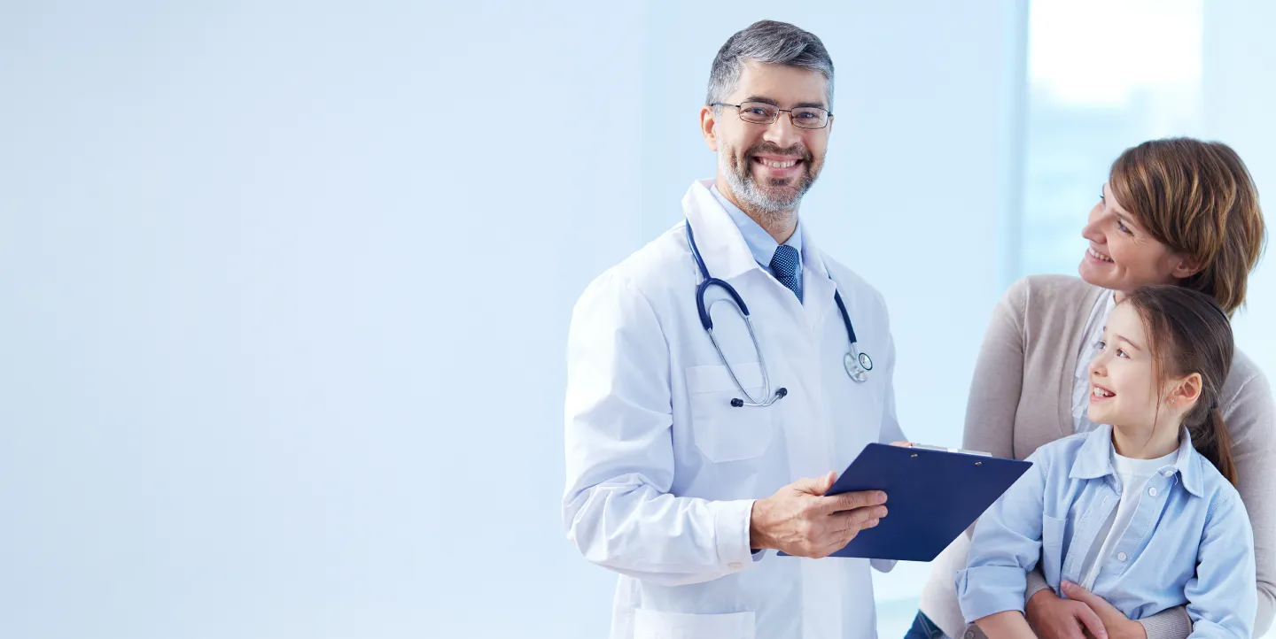 A happy doctor smiling in a clinic, representing quality healthcare services